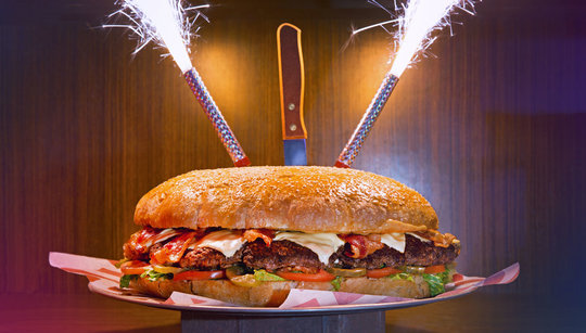 six pound Behemoth burger with sparklers