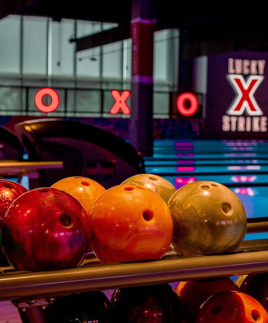 Bowling balls lined up on ball return 
